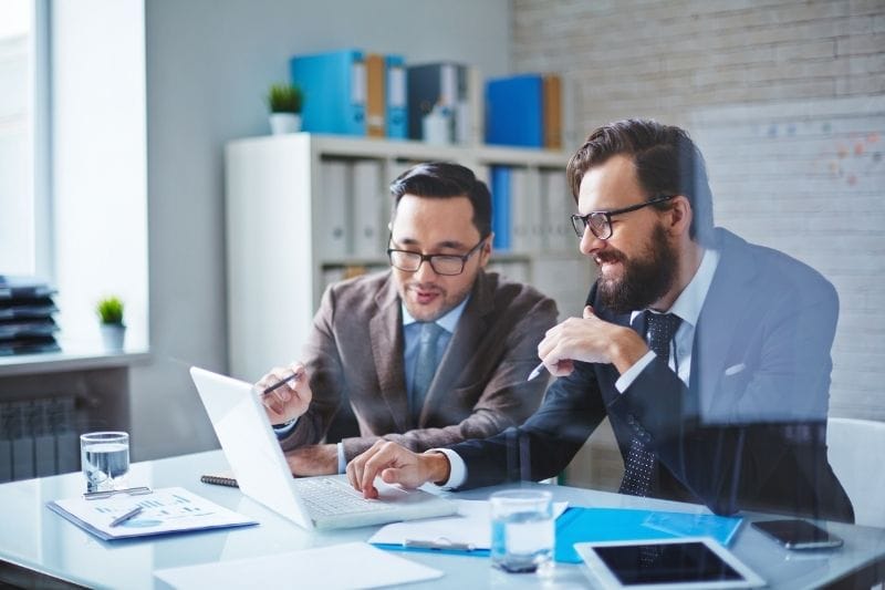 Business consultants reviewing a local SEO strategy on a laptop