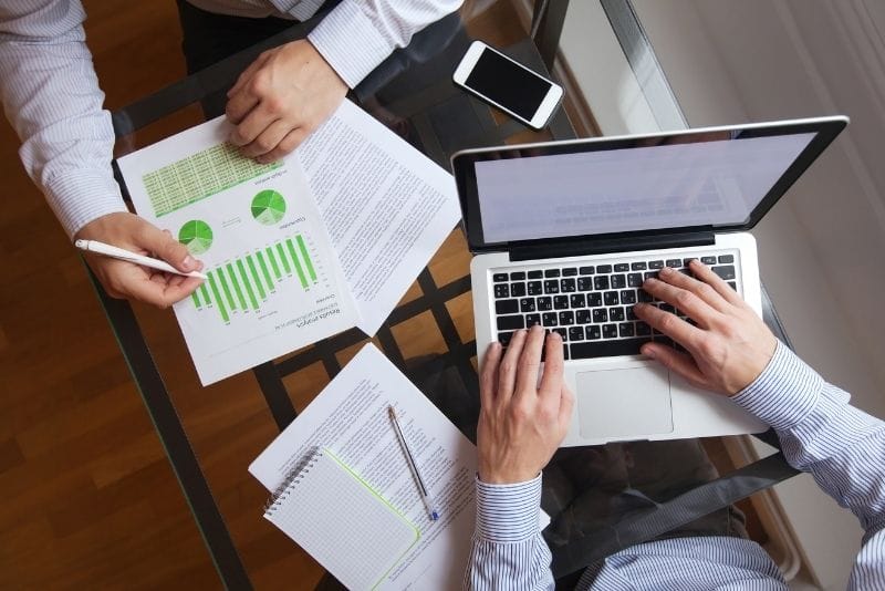 Business owner reviewing marketing reports and growth data