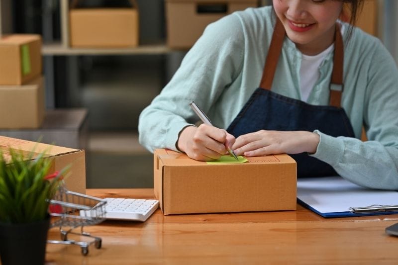 Singapore small business owner managing online orders and customer inquiries